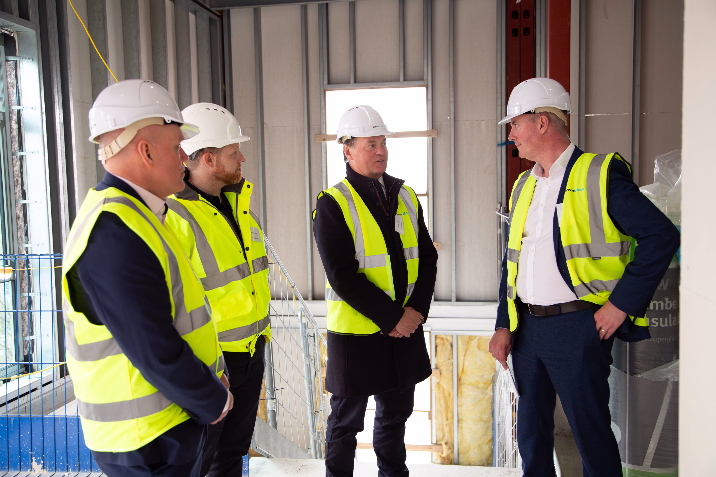 Jim Pierce talking to 3 visitors in the building