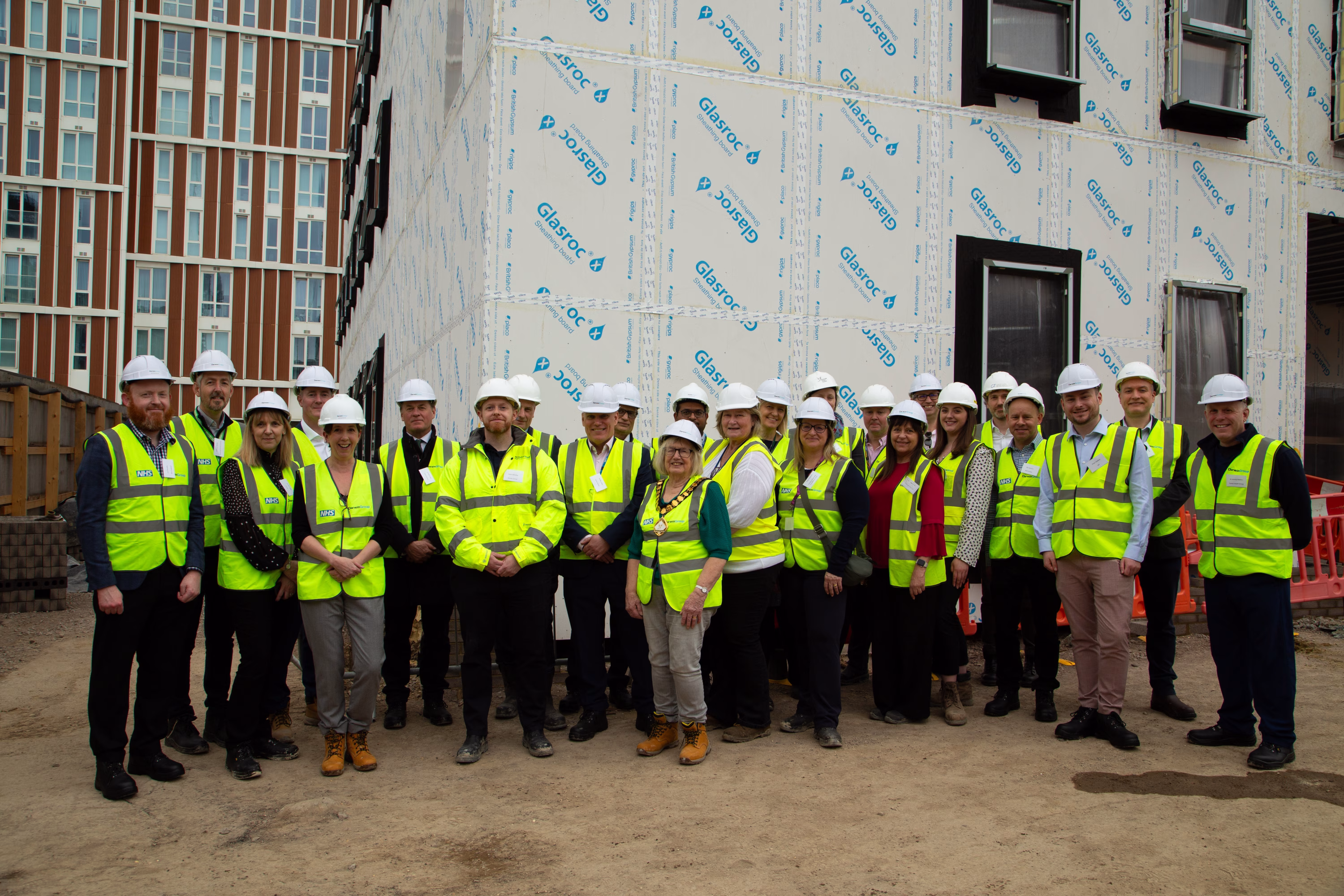 All visitors on the site having a group photo in front of the building