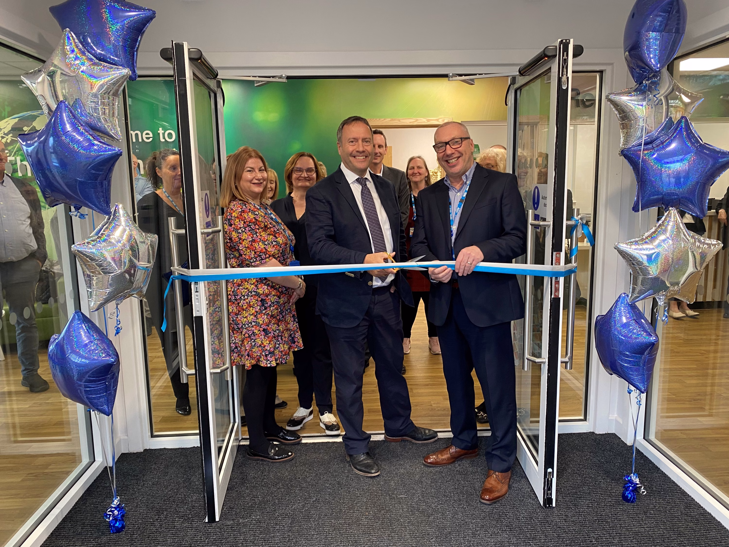 Calderdale Learning Centre opening ceremony - ribbon cutting with a group of people standing in the doorway of the new centre